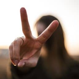 Woman holding up two fingers.
